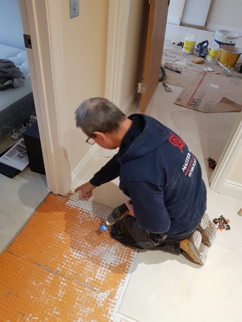 Master Tiling tiler hard at work, installing a new tiled flooring in a lovely London home. 