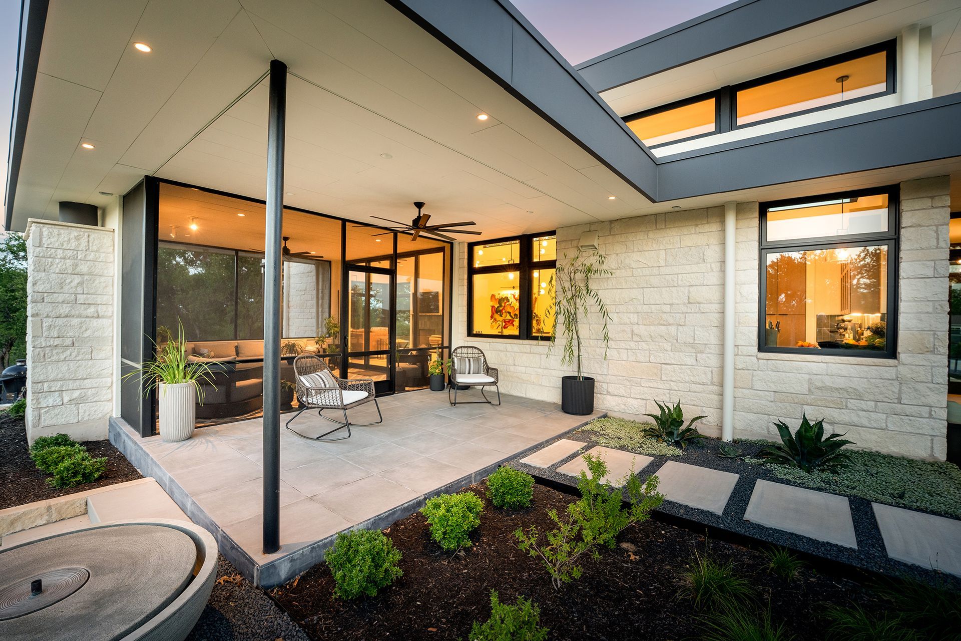 Modern home exterior with outdoor patio and landscaping.