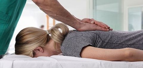 Woman Having Chiropractic Back Adjustment — Chiropractic Clinics in Madisonville, TN