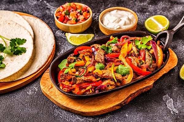 Fajitas with Colored Pepper and Onions — Muskegon, MI — Los Amigos Mexican Bar & Grill