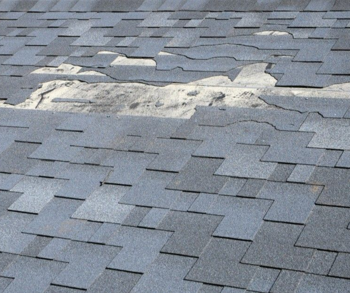 A close up of a roof with shingles missing