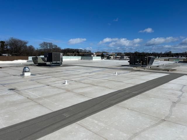 The roof of a building with a blue sky in the background