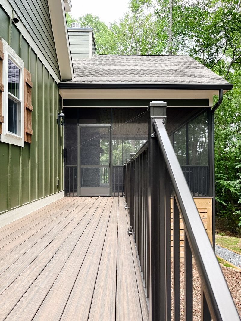 Green house with screened porch and composite deck.