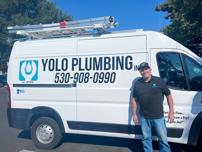 joe weins posed in front of yolo plumbing work van