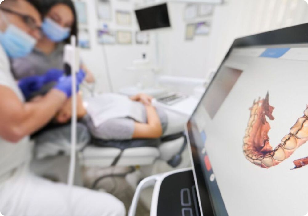 A dentist is examining a patient 's teeth in a dental office