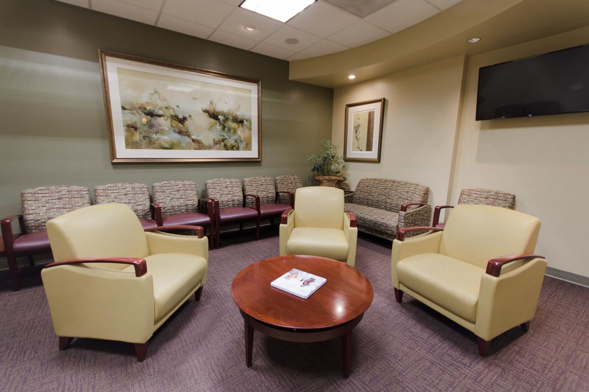 A waiting room with lots of chairs and a table