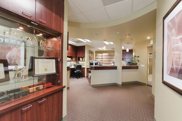 A hallway leading to a reception area in a dental office.