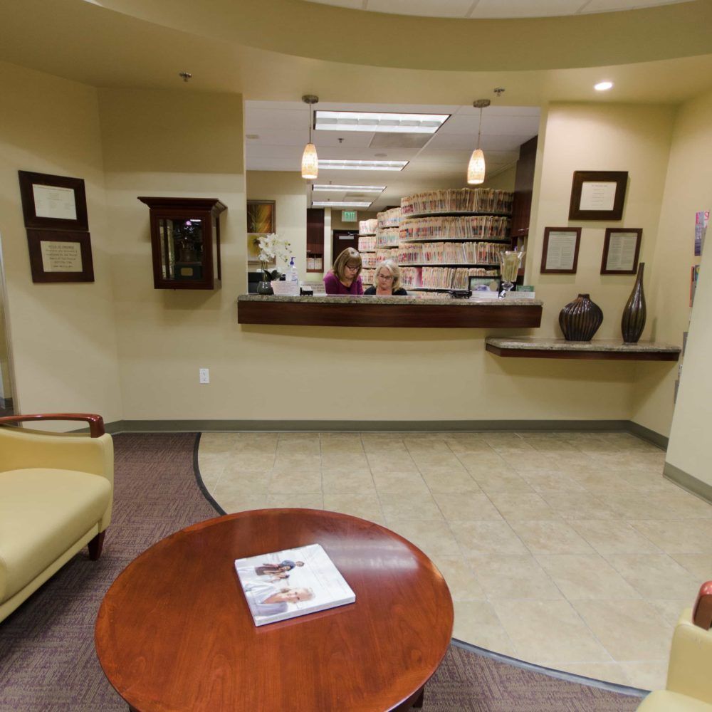 A woman sits at a counter in a waiting room