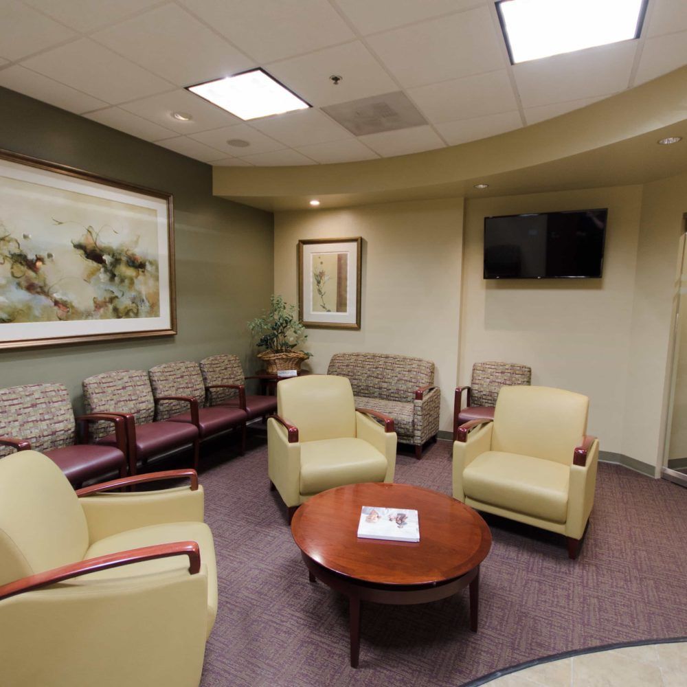 A waiting room with chairs and a coffee table