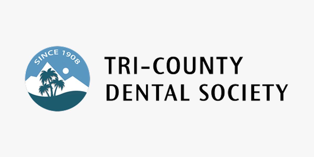 The tri-county dental society logo has a mountain and trees in it.