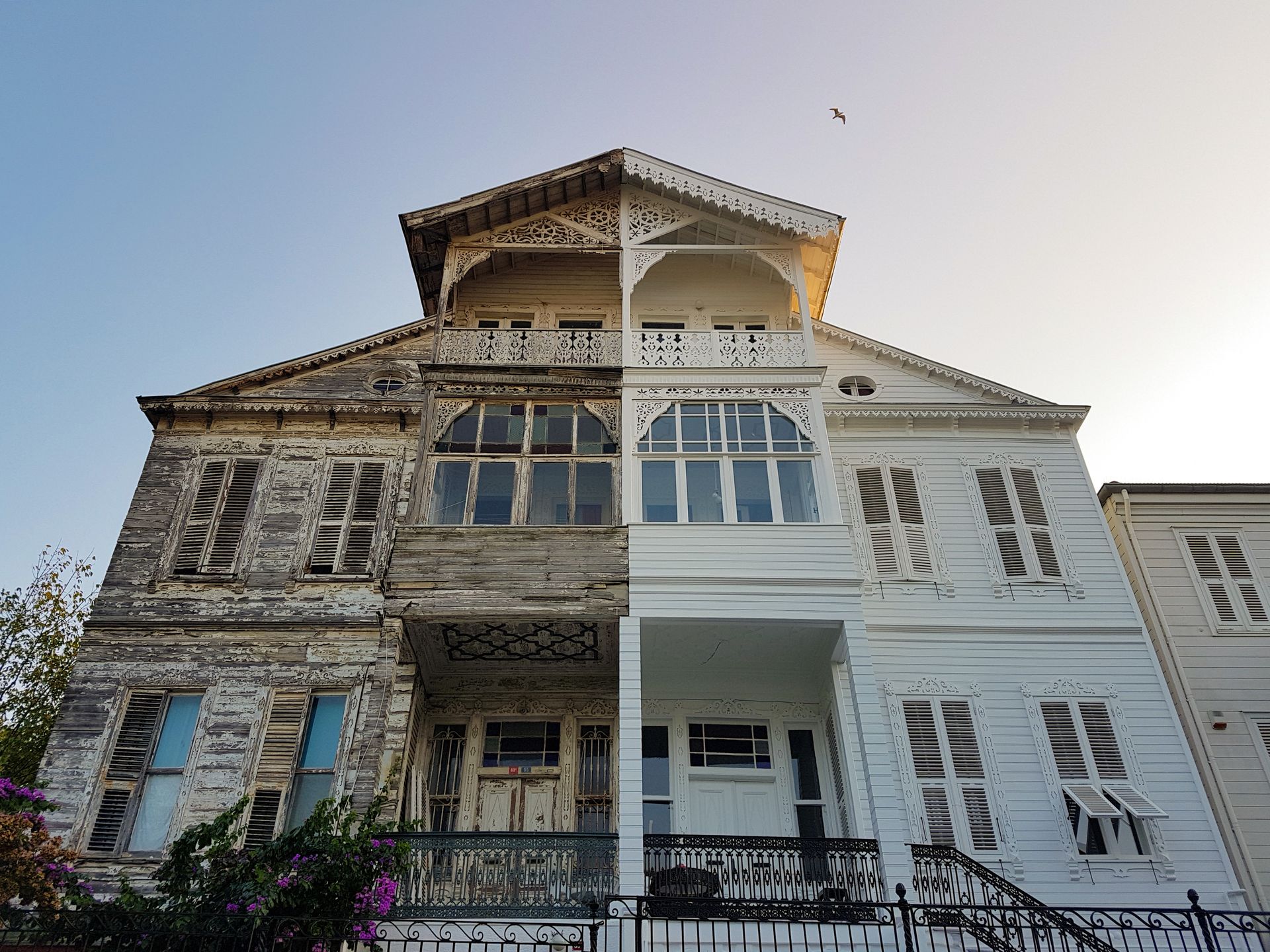 Couple reviewing blueprints with a real estate agent in an empty home.