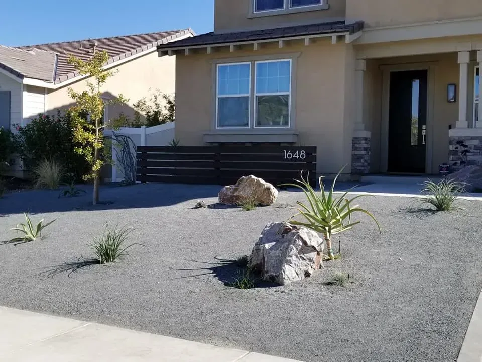 A house with a lot of rocks in front of it