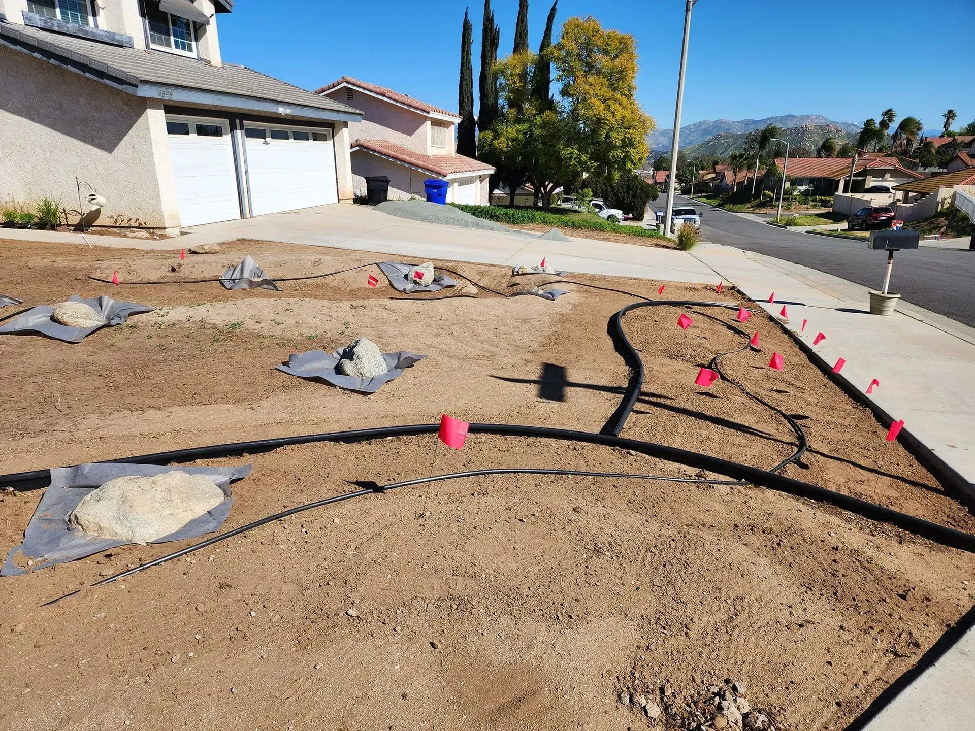 A residential area with a lot of dirt and a house in the background