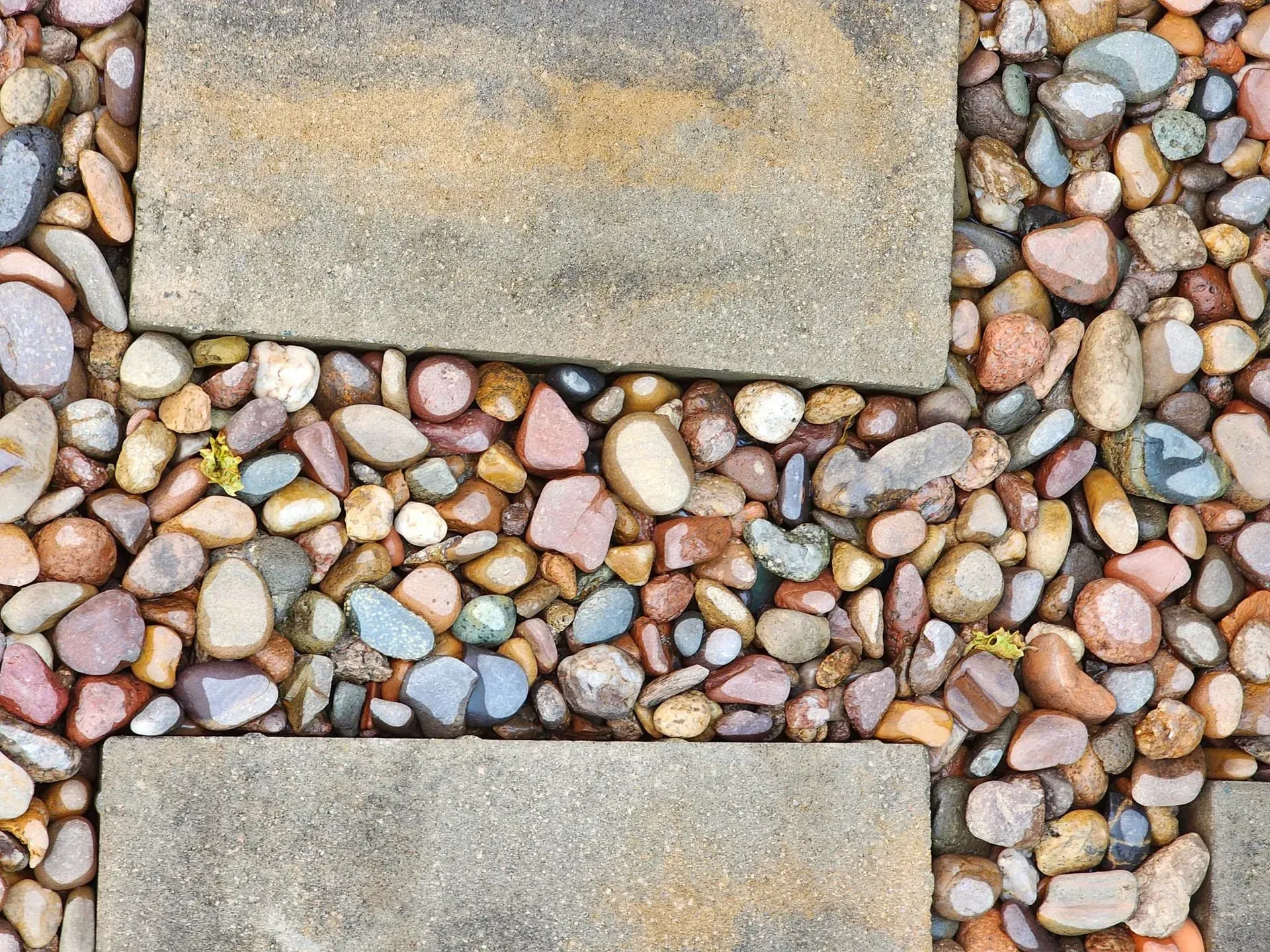 A close up of a stone walkway surrounded by rocks.