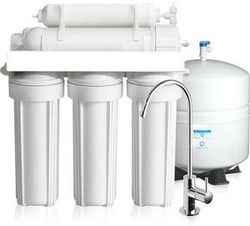 A water filter with a faucet and a tank.