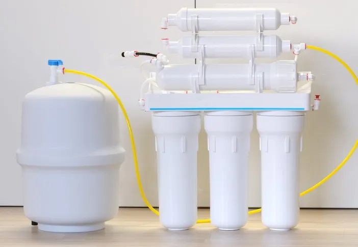 White reverse osmosis water filtration system and storage tank.