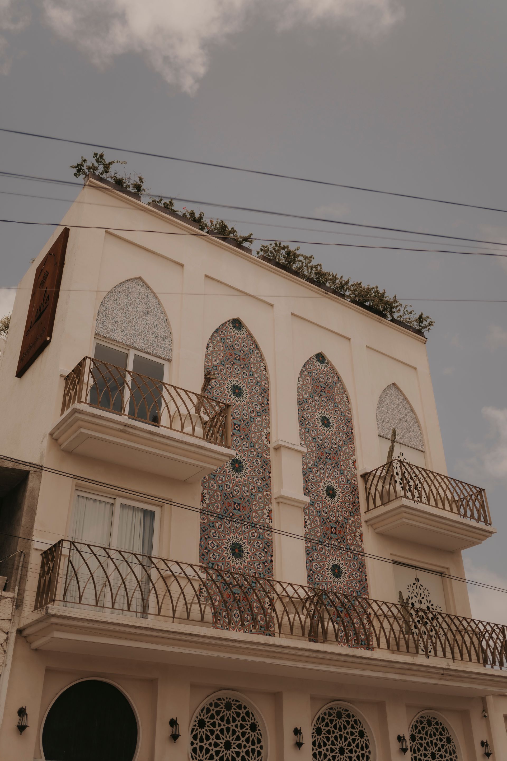 A large white building with a balcony on the top of it.