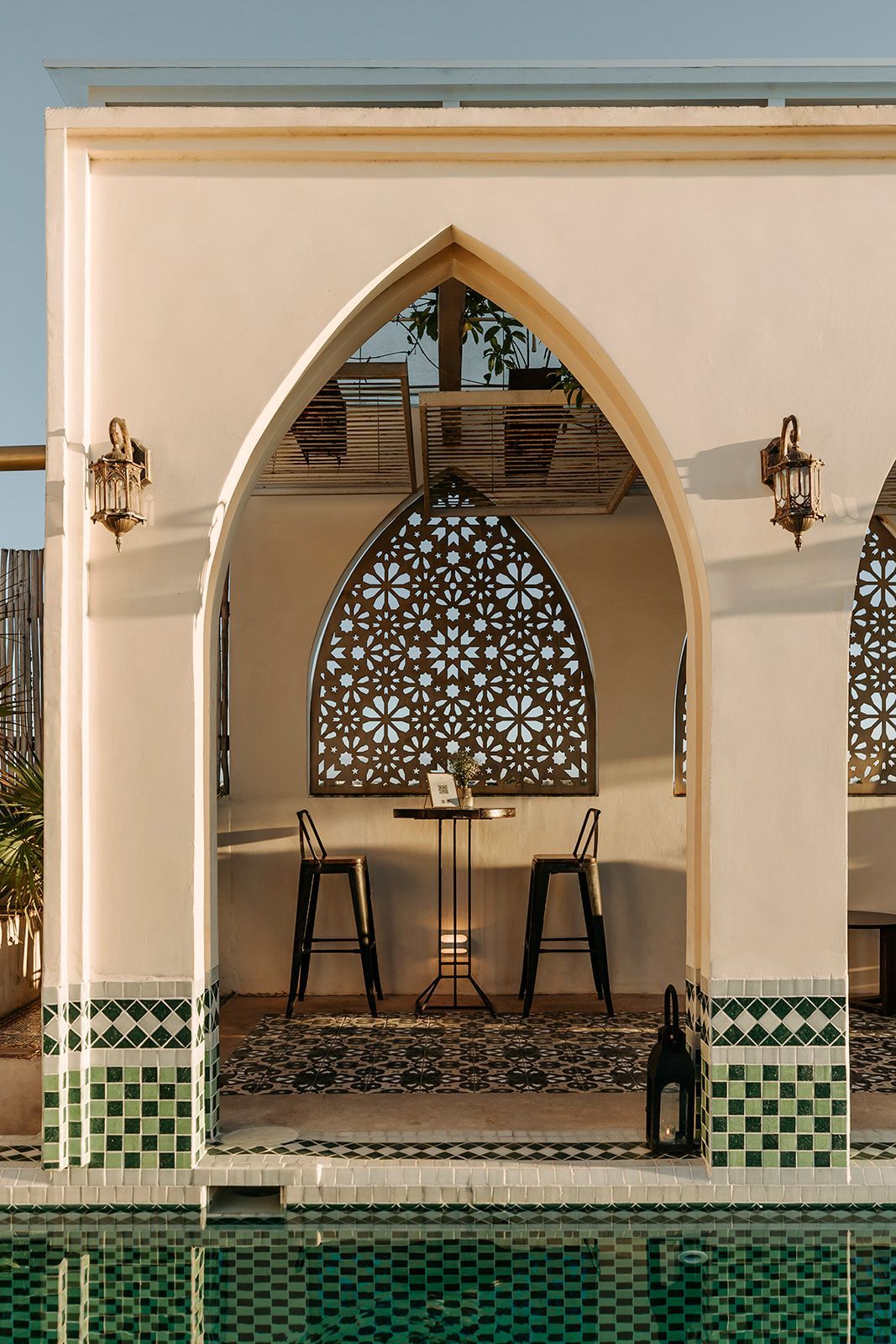 A white building with a swimming pool in front of it
