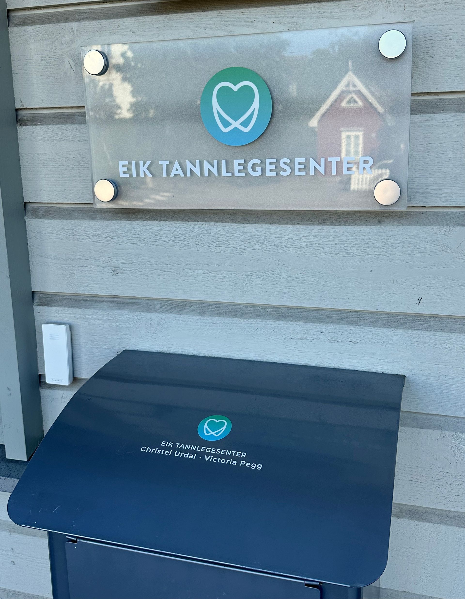 Et skilt på en vegg hvor det står eik tannlegesenter