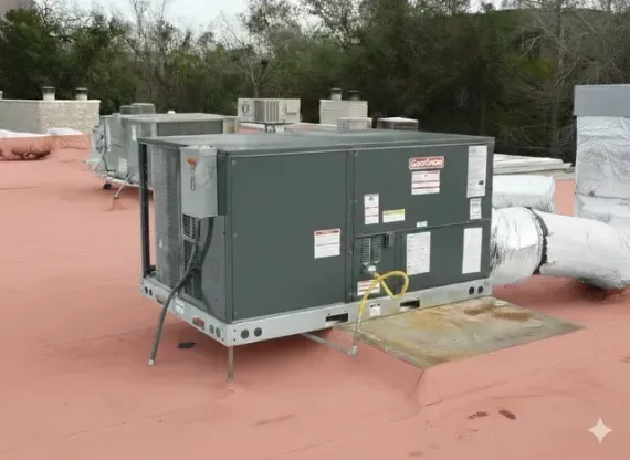 Green rooftop HVAC unit on a red flat roof with vents and surrounding trees