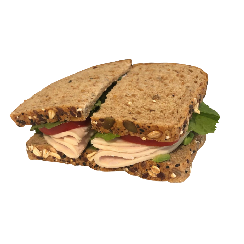 A sandwich with turkey and lettuce is cut in half from farm fresh