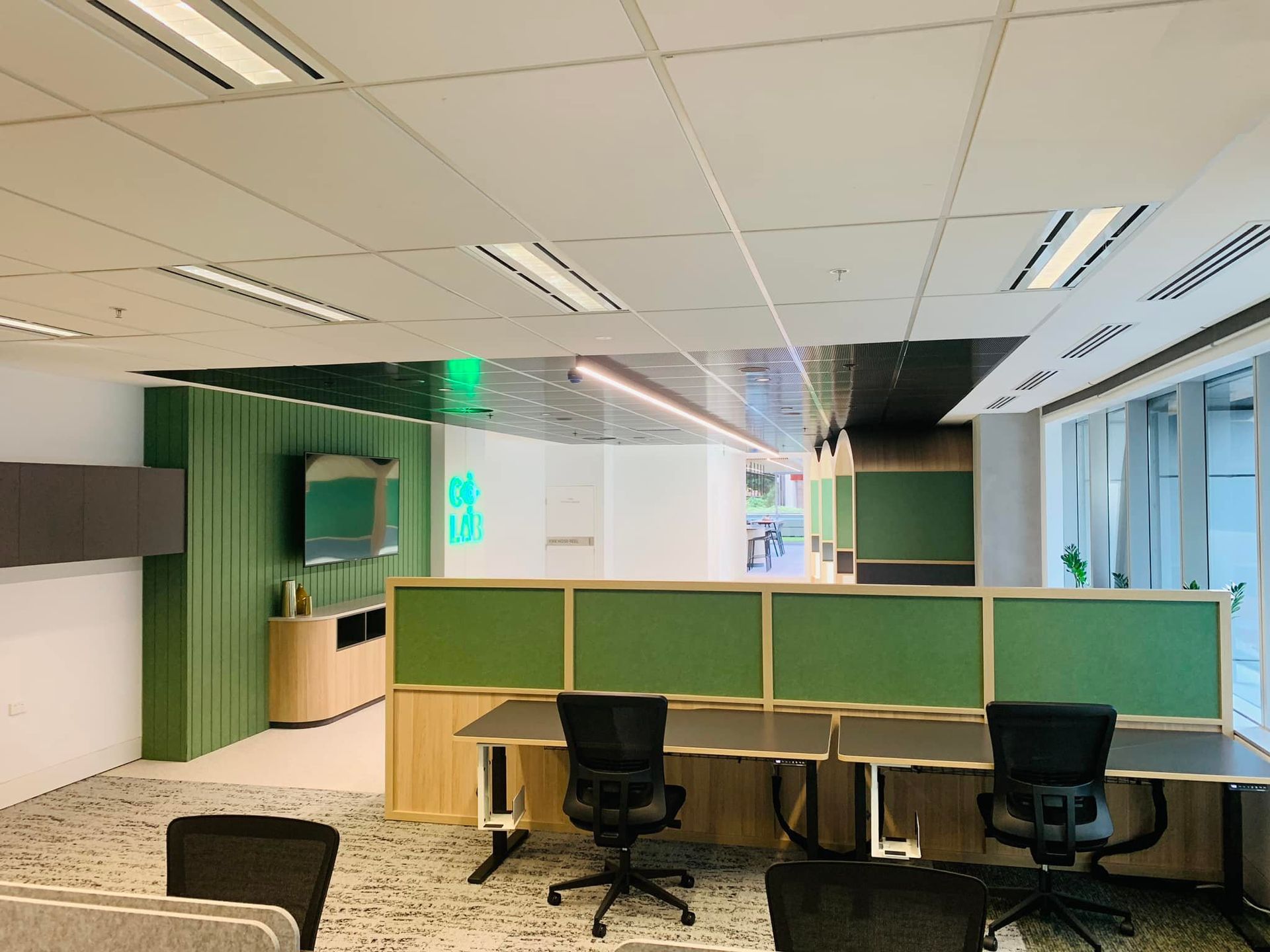 A large office with a lot of desks and chairs.