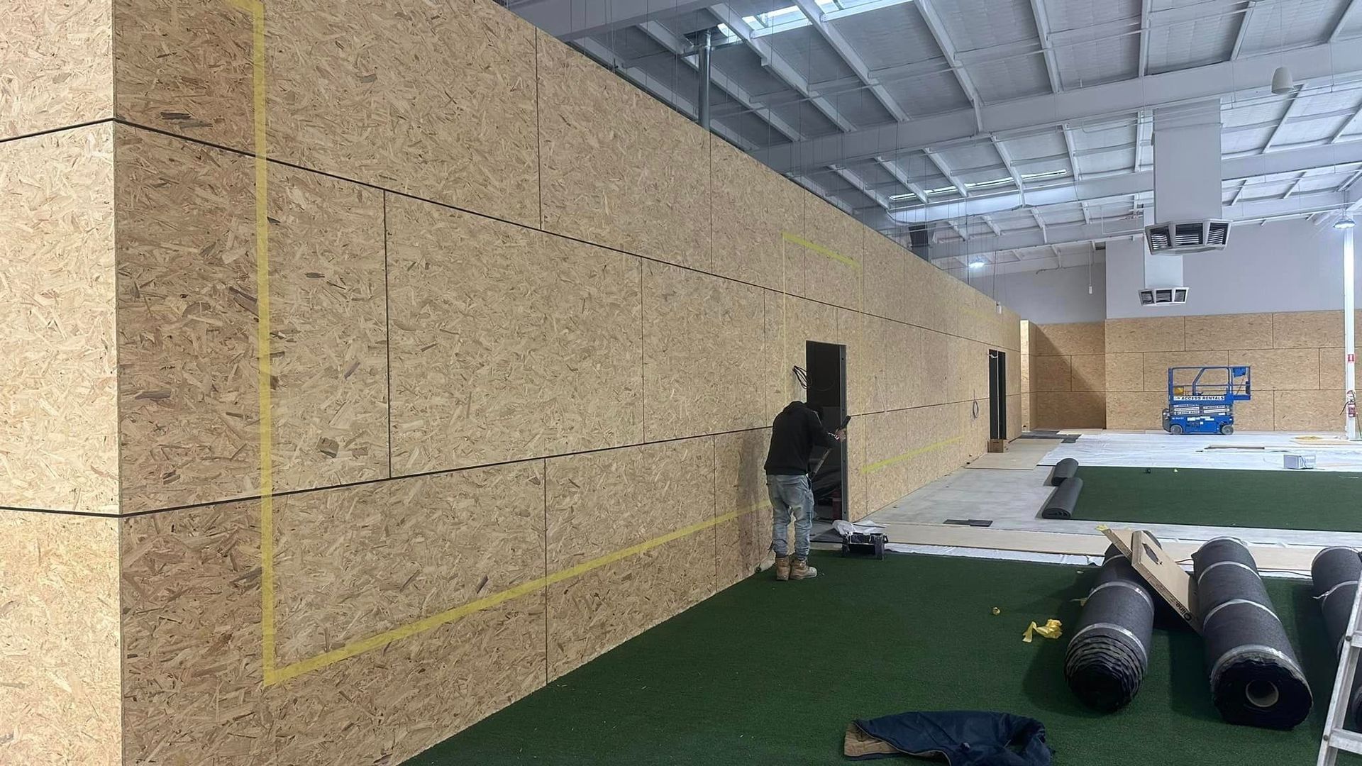 A man is standing in front of a wall in a building.