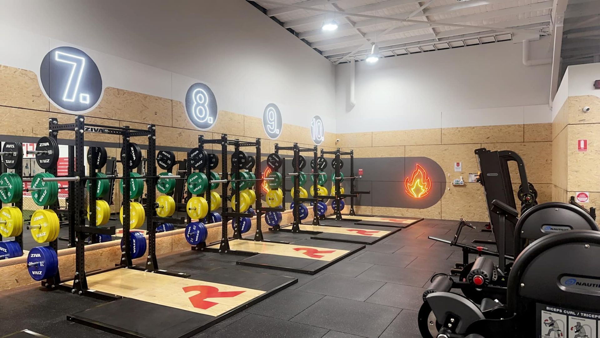 A gym with a lot of exercise equipment and a sign that says 7.