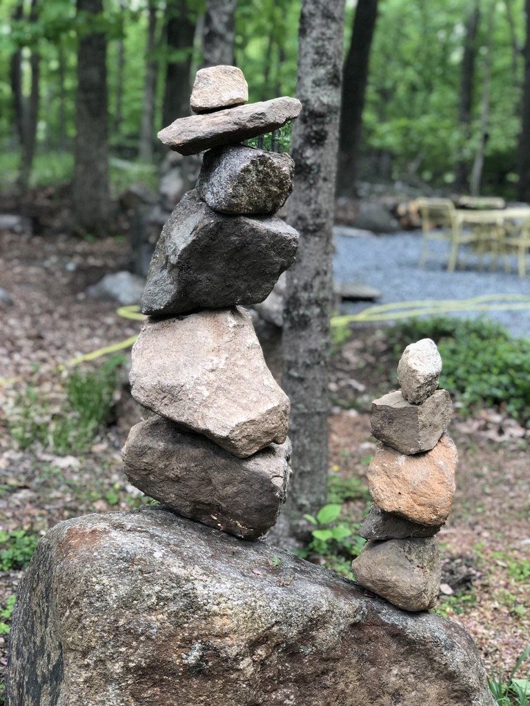 A pile of rocks stacked on top of each other in the woods.