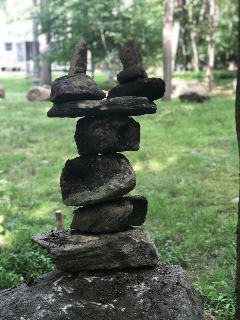 A pile of rocks stacked on top of each other in a park.