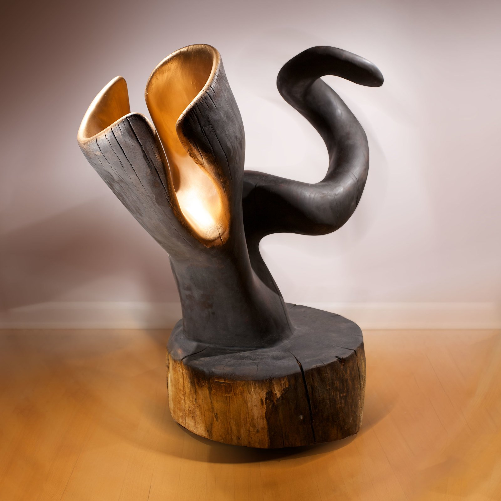 A black and gold sculpture is sitting on a wooden table