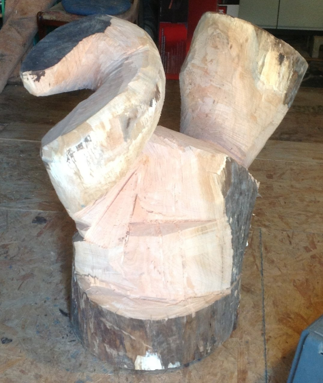 A large piece of wood is sitting on a wooden floor