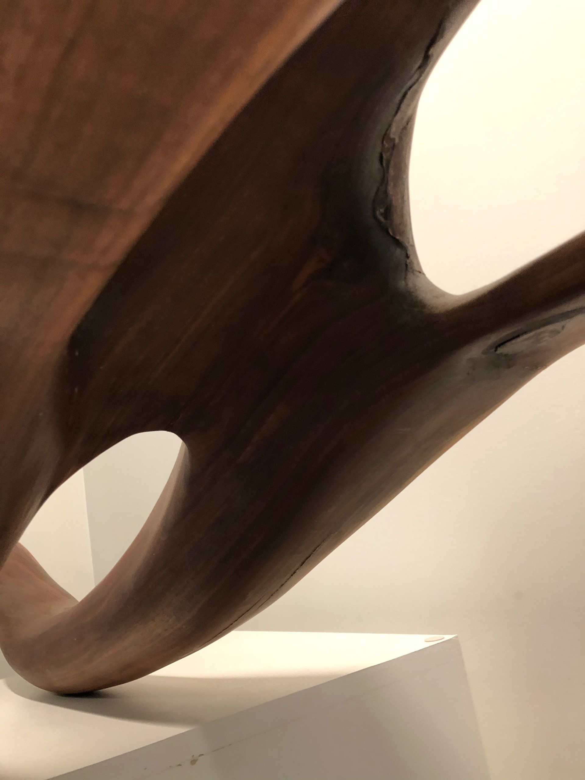 A close up of a wooden sculpture with a hole in the middle