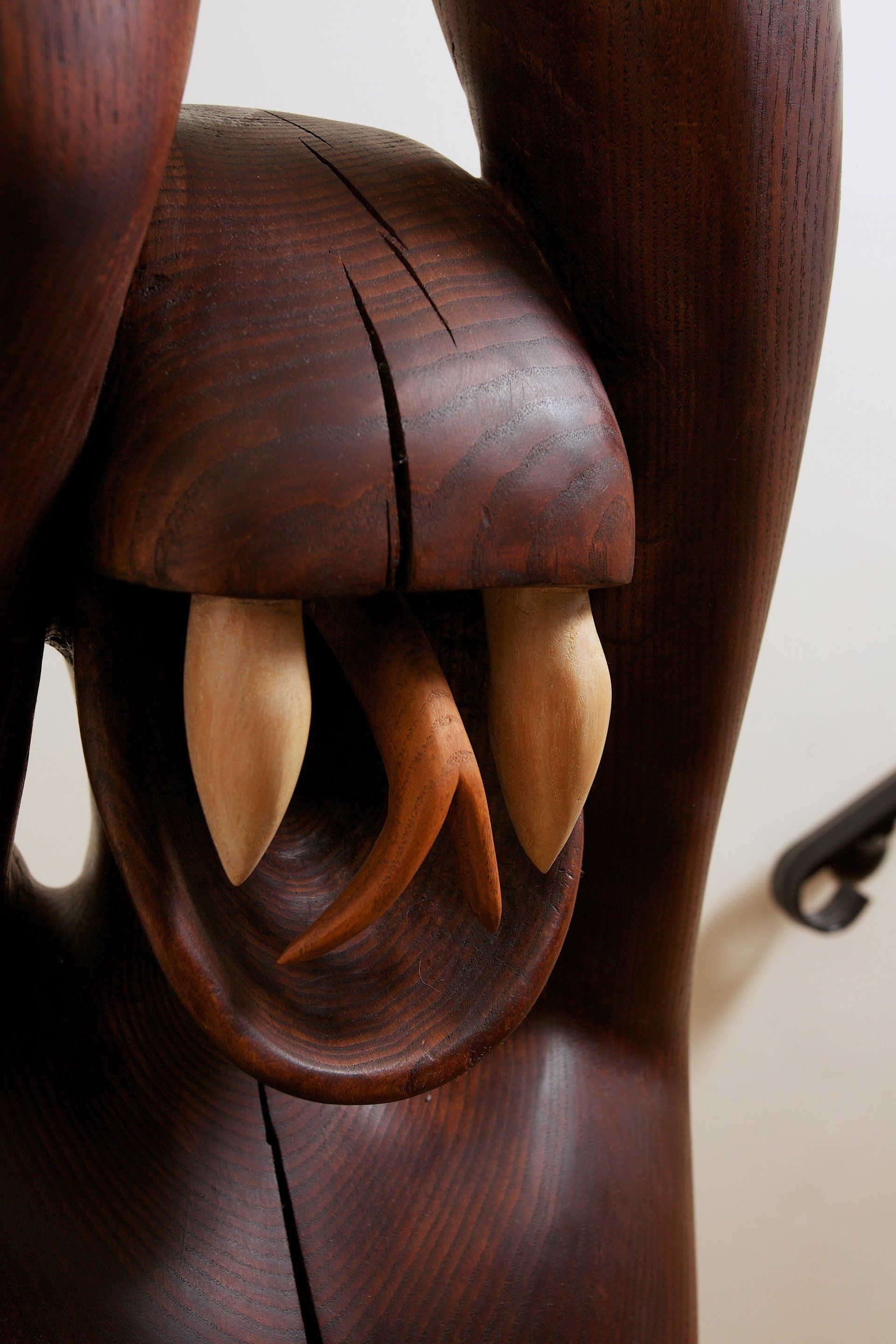 A close up of a wooden statue with teeth