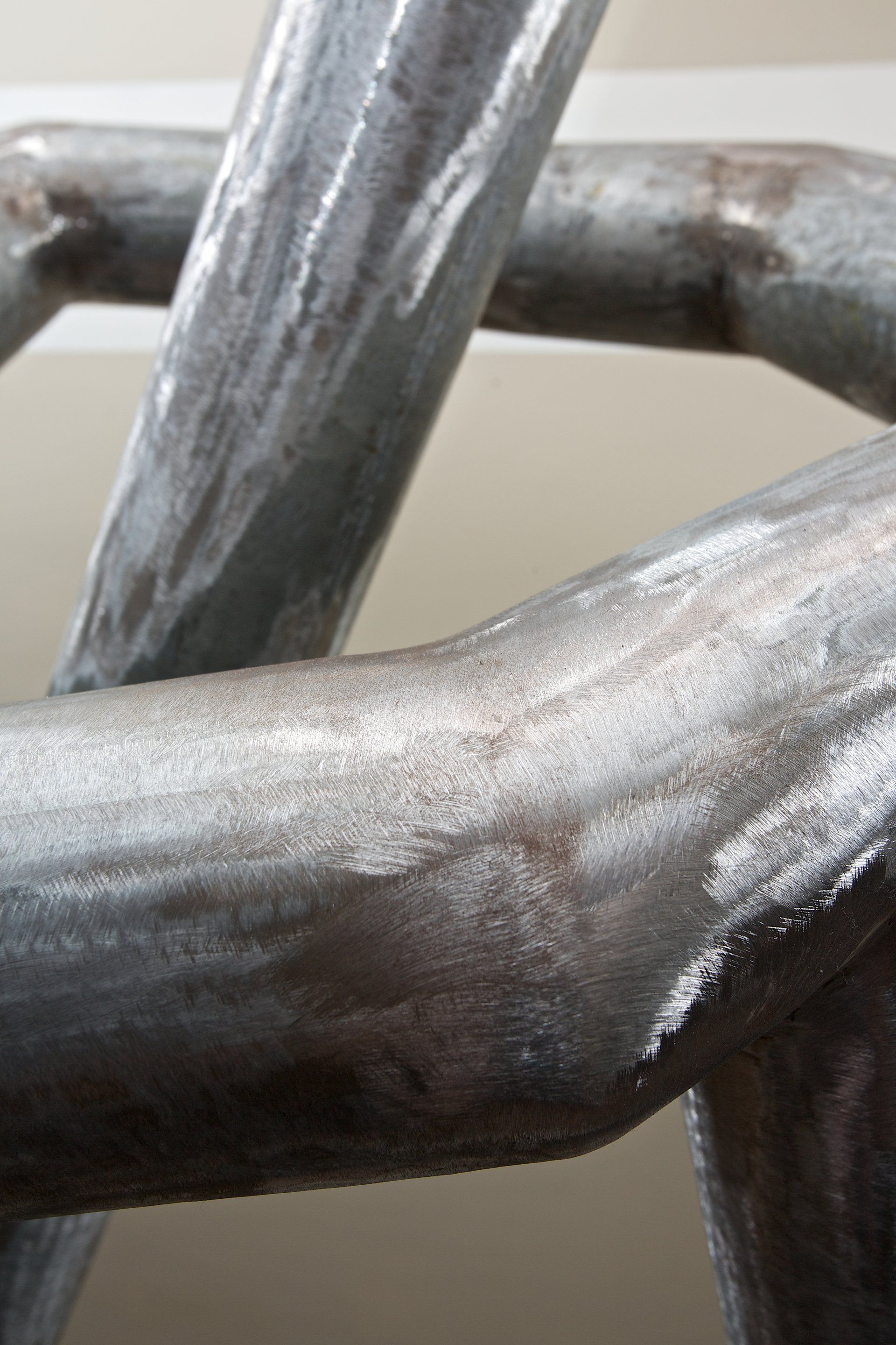 A close up of a metal pipe on a wall.