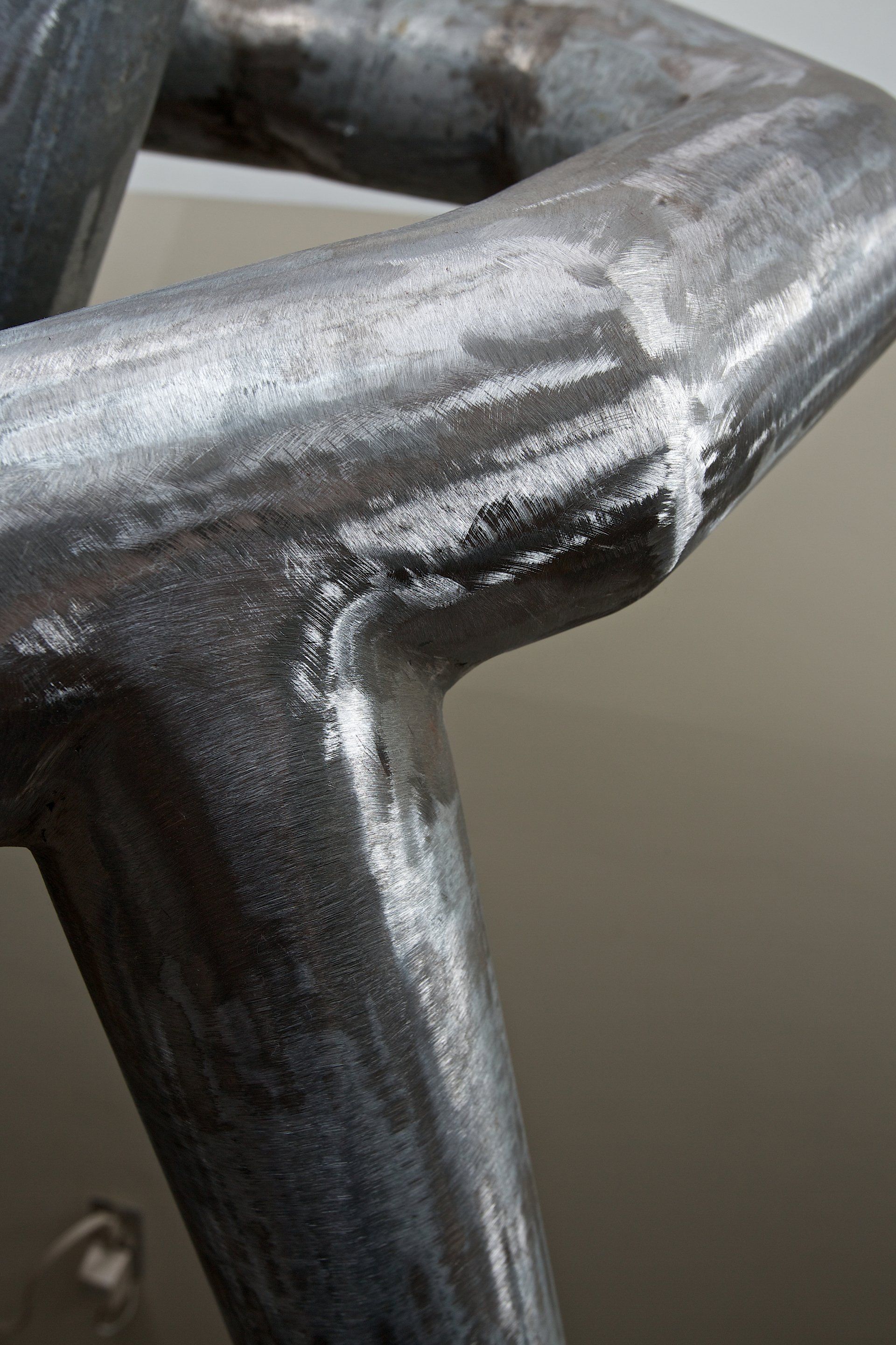 A close up of a metal pipe on a wall.