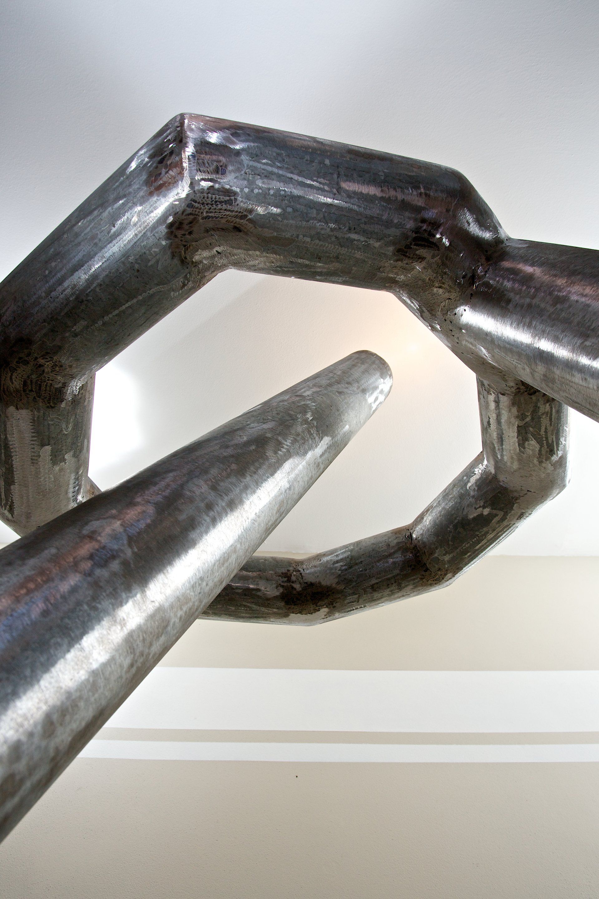 A close up of a metal object hanging from the ceiling.