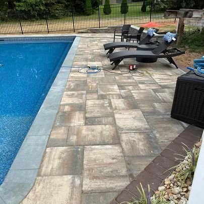 A patio with a table and chairs and a grill.