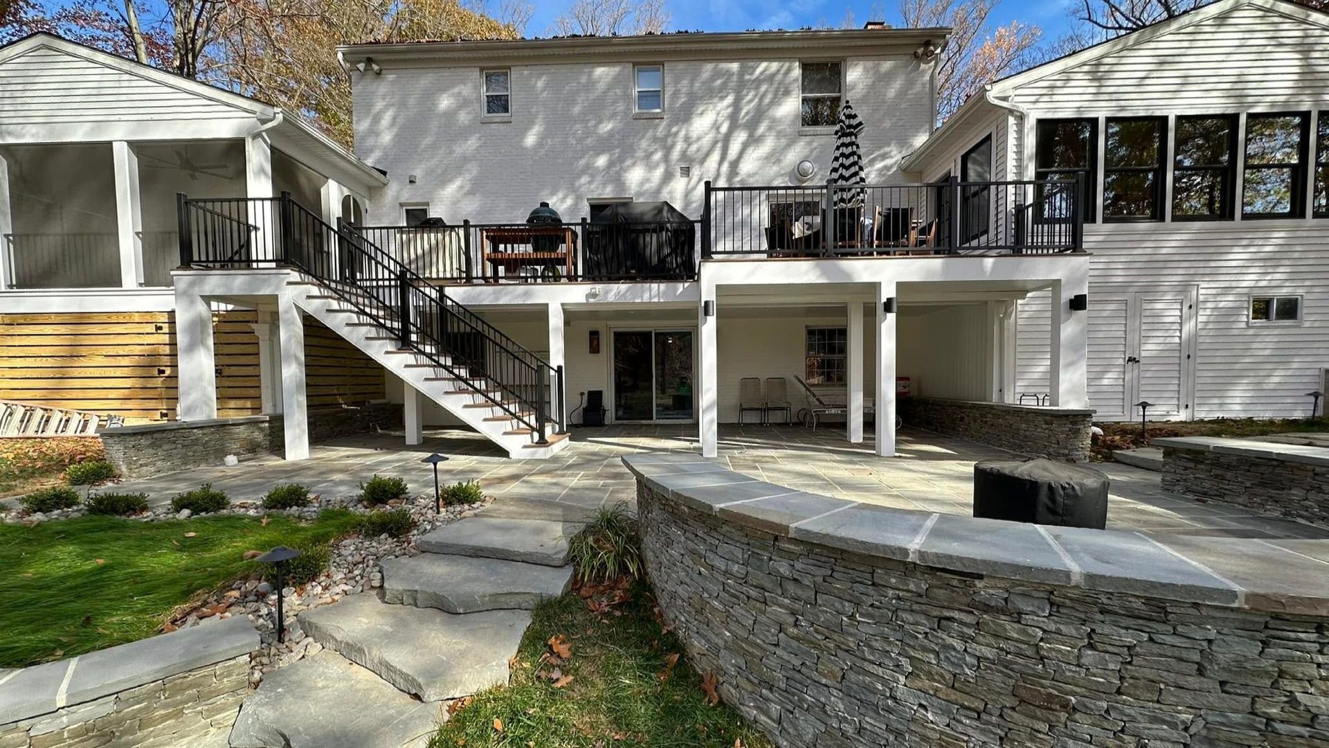 Custom multi-use patio and deck designed by X2N in Maryland for year-round outdoor living.