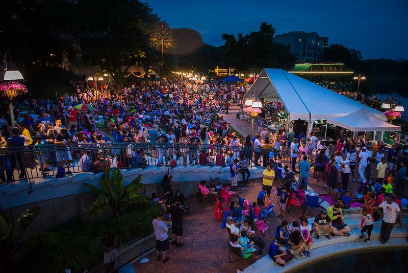 Crowd gathered with lawn chairs and blankets at the Columbia Lakefront Fourth of July Celebration in Maryland, waiting for the fireworks to begin.
