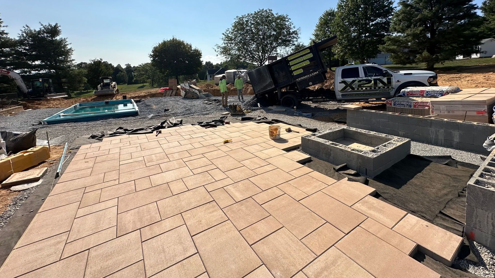 Custom paver patio under construction by X2N, a Maryland outdoor living and hardscaping company