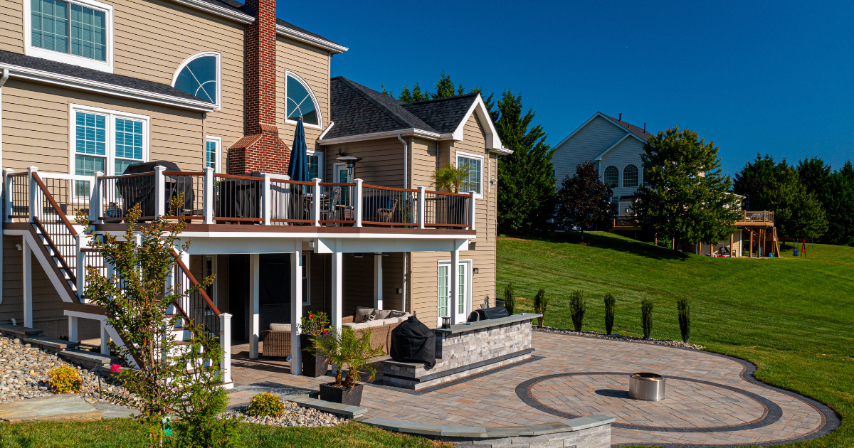 Large multi-purpose outdoor living space with outdoor kitchen and firepit in Maryland