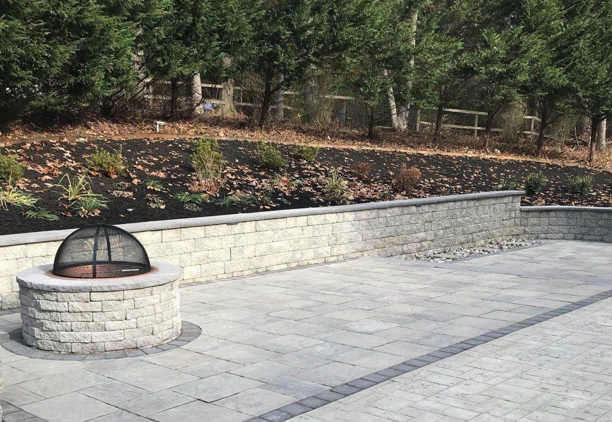 There is a fire pit in the middle of the patio.