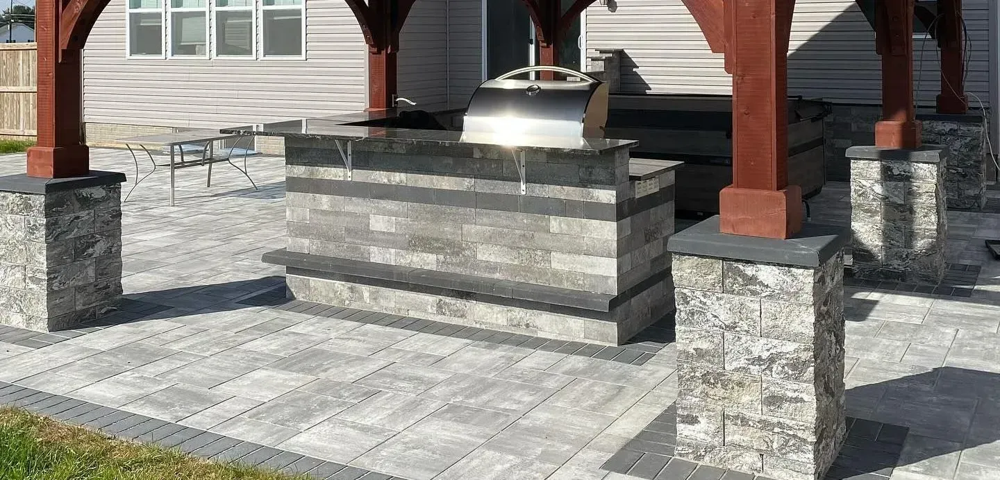 Patio with covered outdoor kitchen designed for year-round Maryland outdoor living.