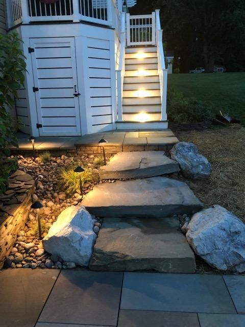 A set of stairs leading up to a deck with lights on them