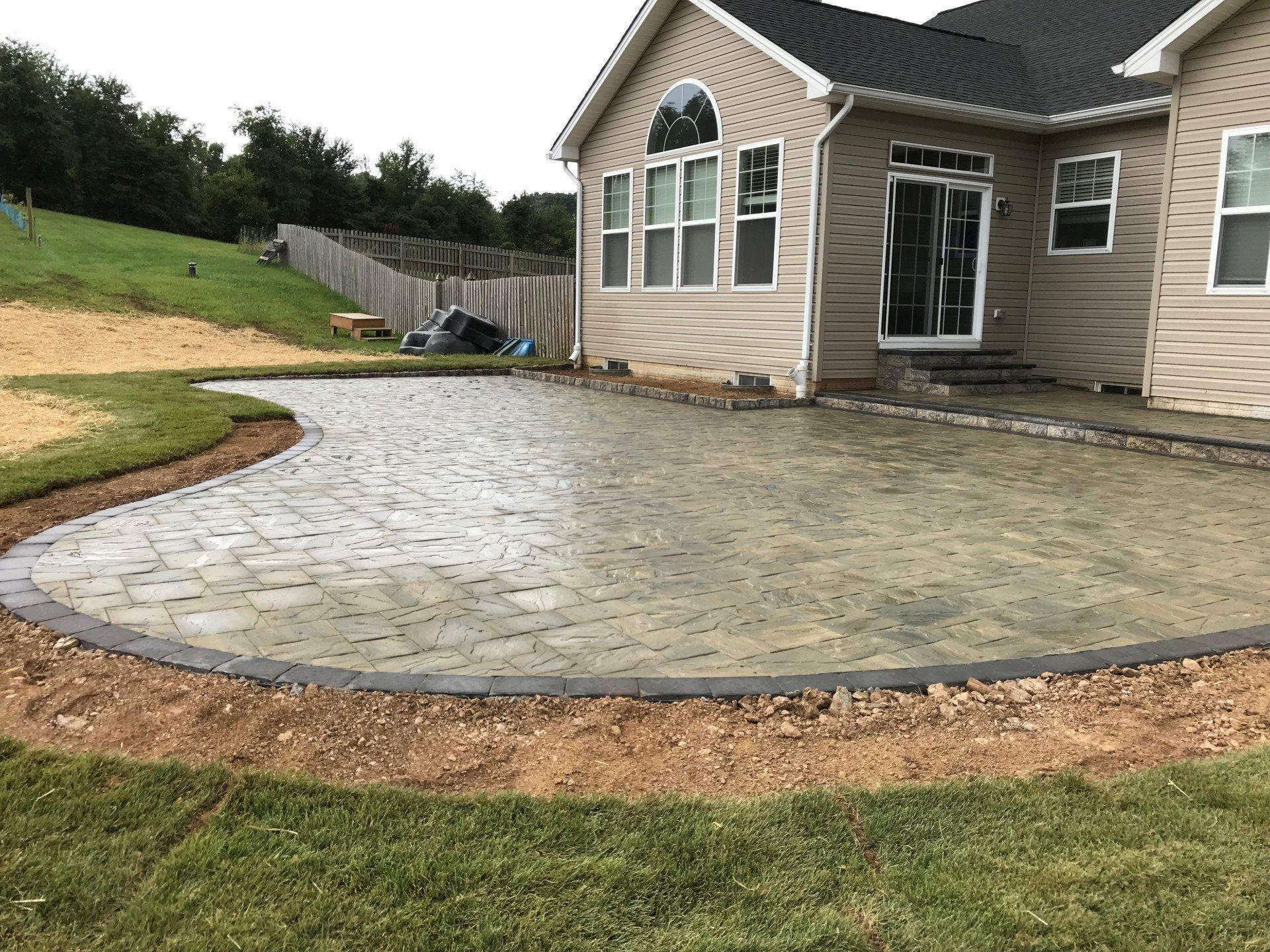 A large house with a patio in front of it.
