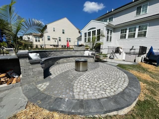 There is a fire pit in the middle of the patio.
