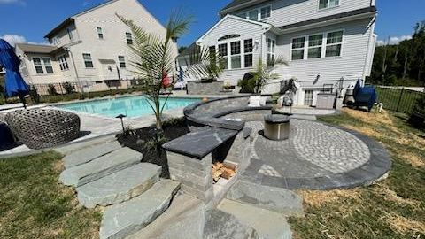 A large white house with a swimming pool in the backyard.