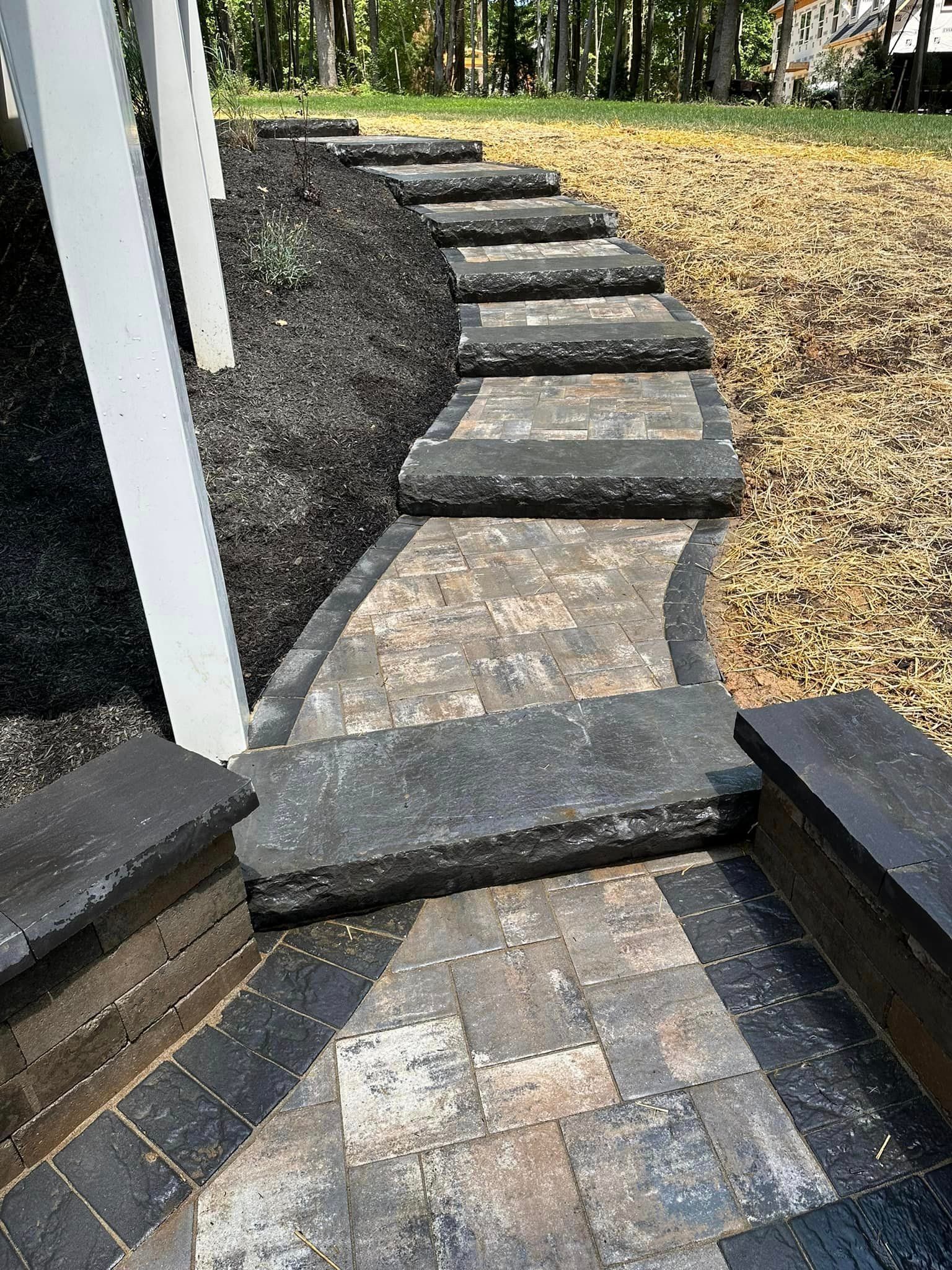 A stone walkway with steps leading up to a house.