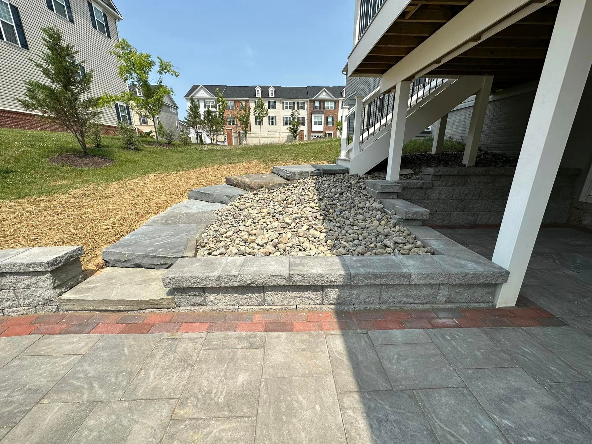 A house with a patio and stairs underneath it